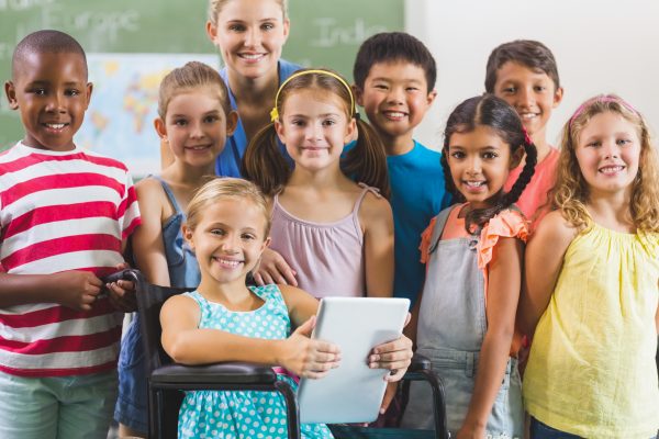 group of kids standing with their teacher