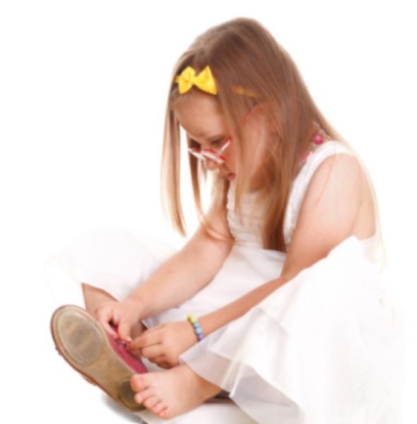 young girl playing with the clasp on her shoe